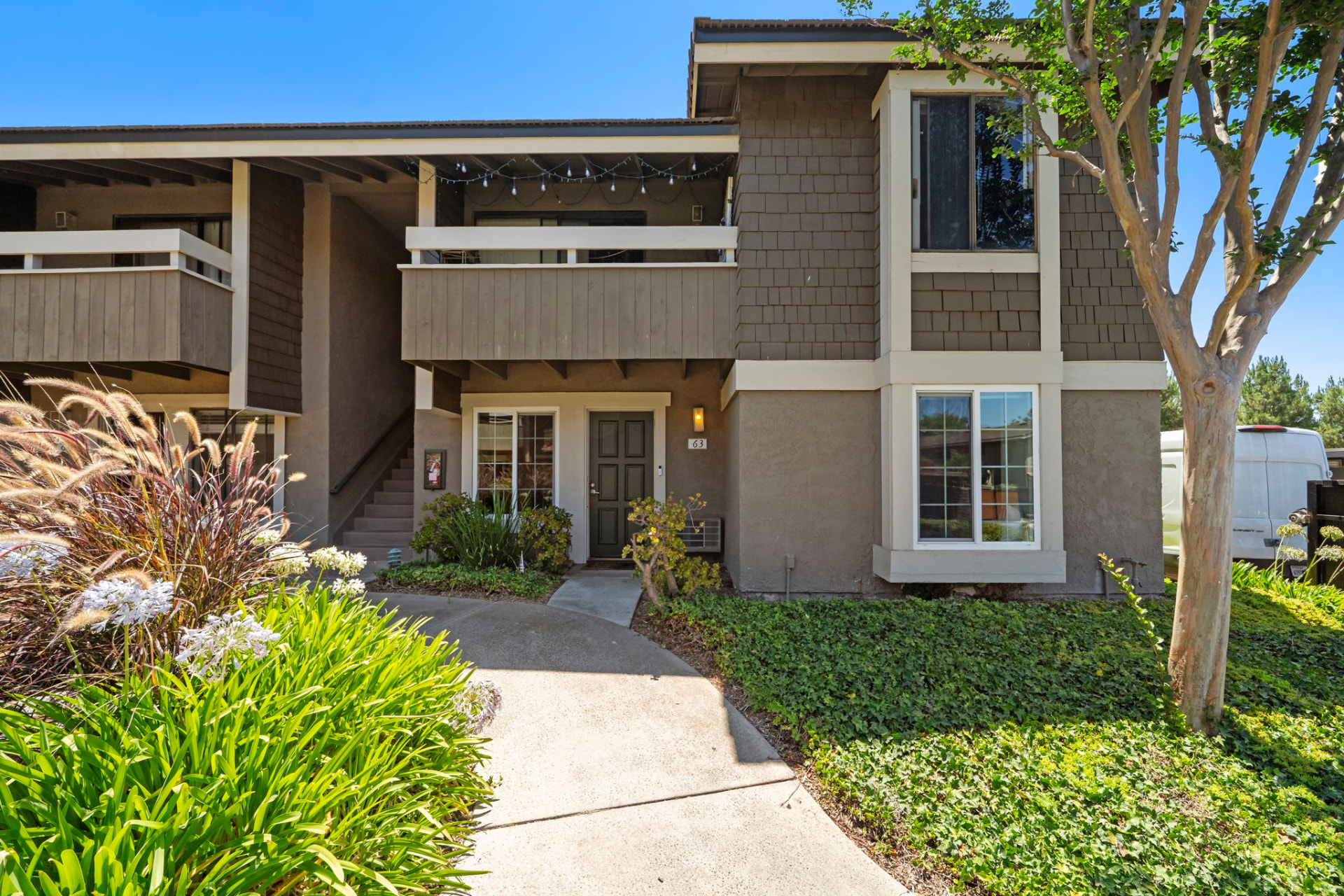 Entry to a two-story Irvine townhome with mature landscaping