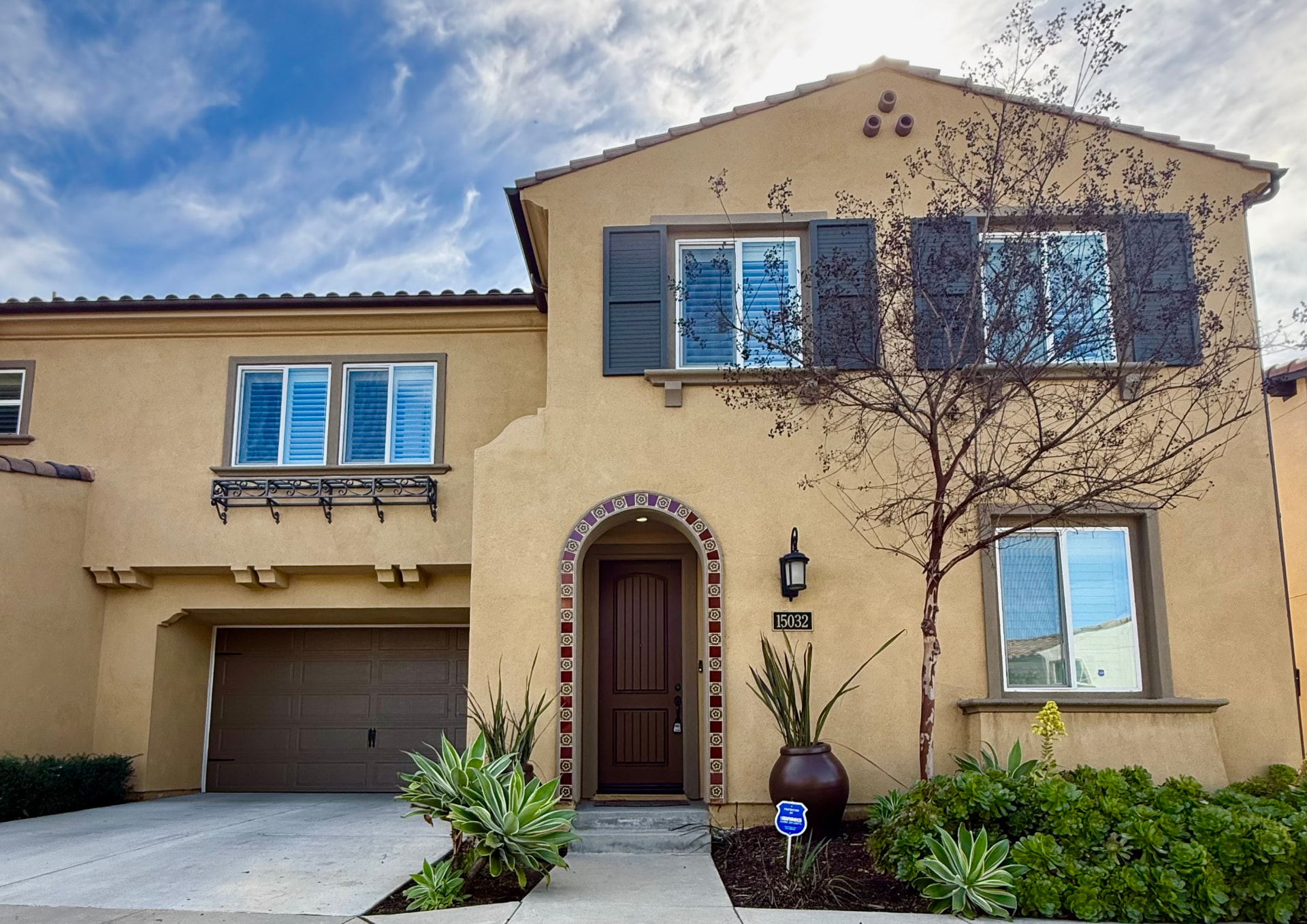 Two-story La Mirada home with Spanish-inspired entry and landscaped front garden