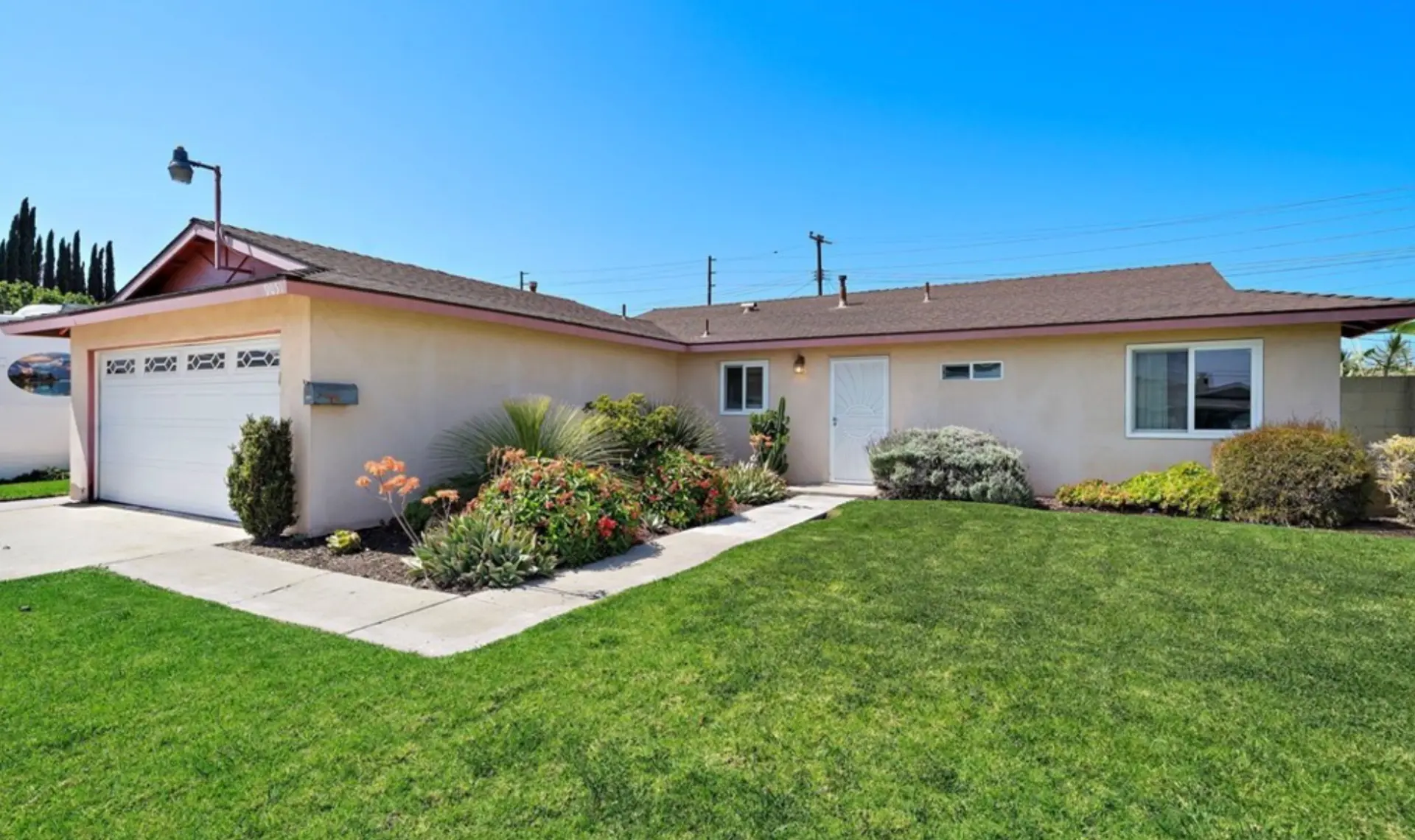 Single-story Westminster home with green lawn and drought-tolerant garden beds