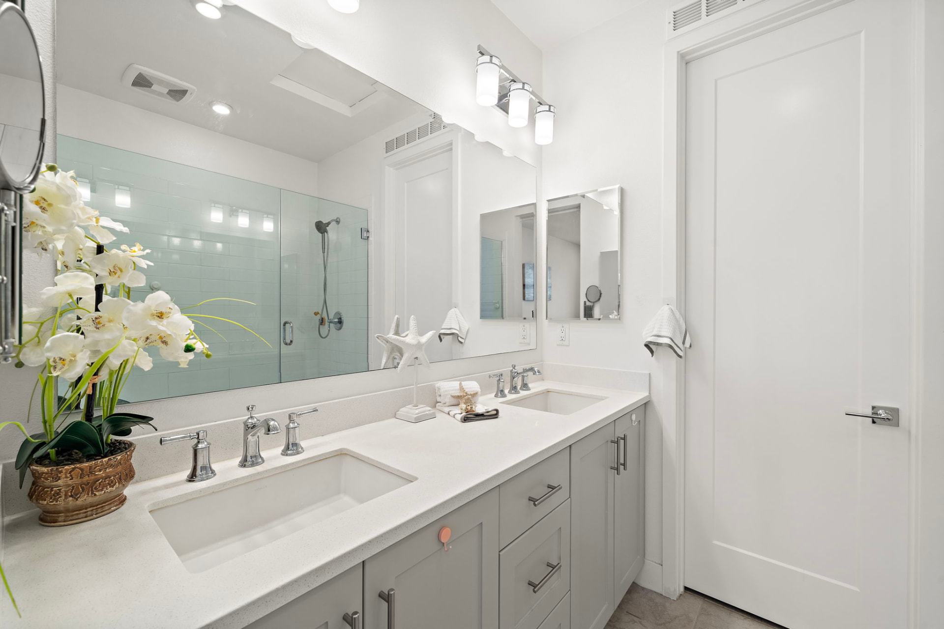 Primary bathroom with dual sinks and walk-in shower at 230 Abacus