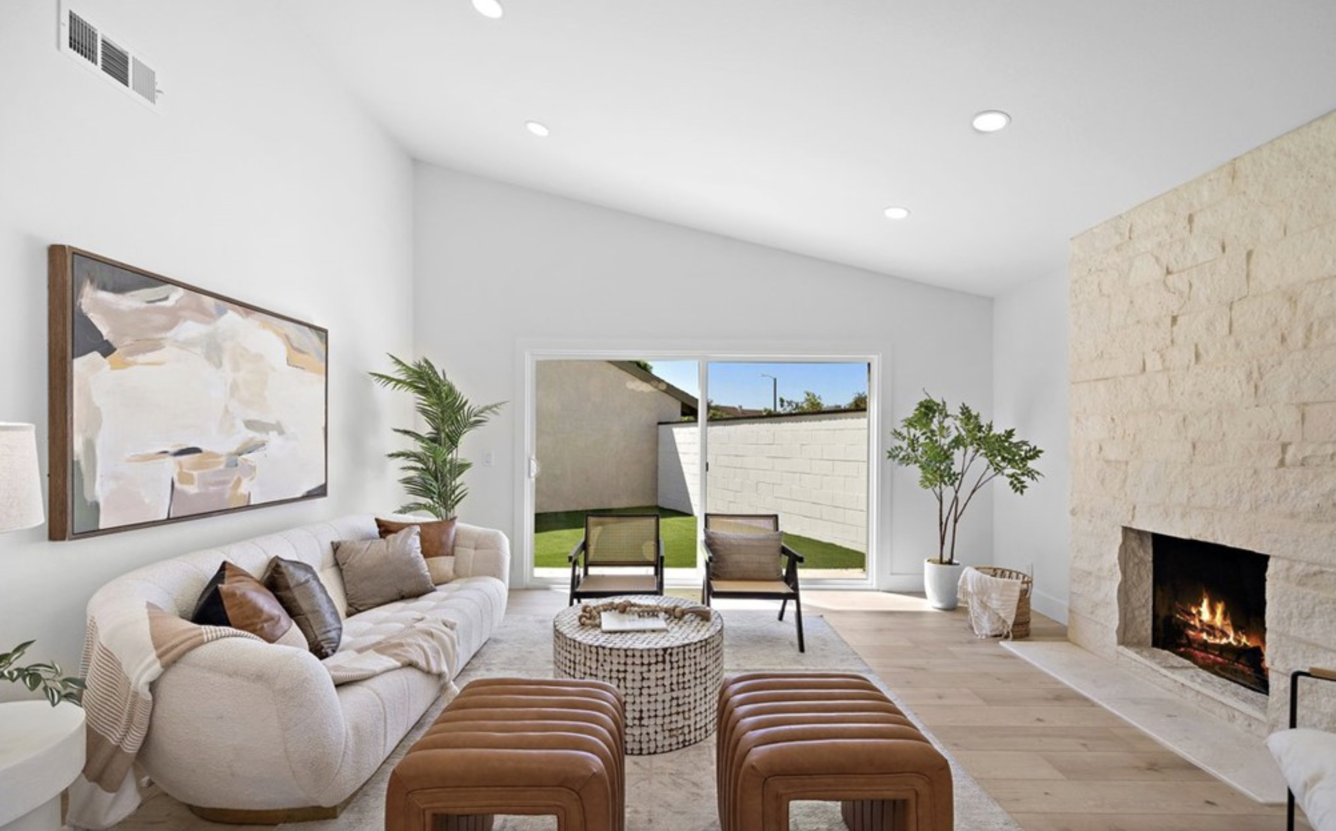 Living room at 17248 Reimer Street with vaulted ceilings, stone fireplace and sliding doors to the backyard