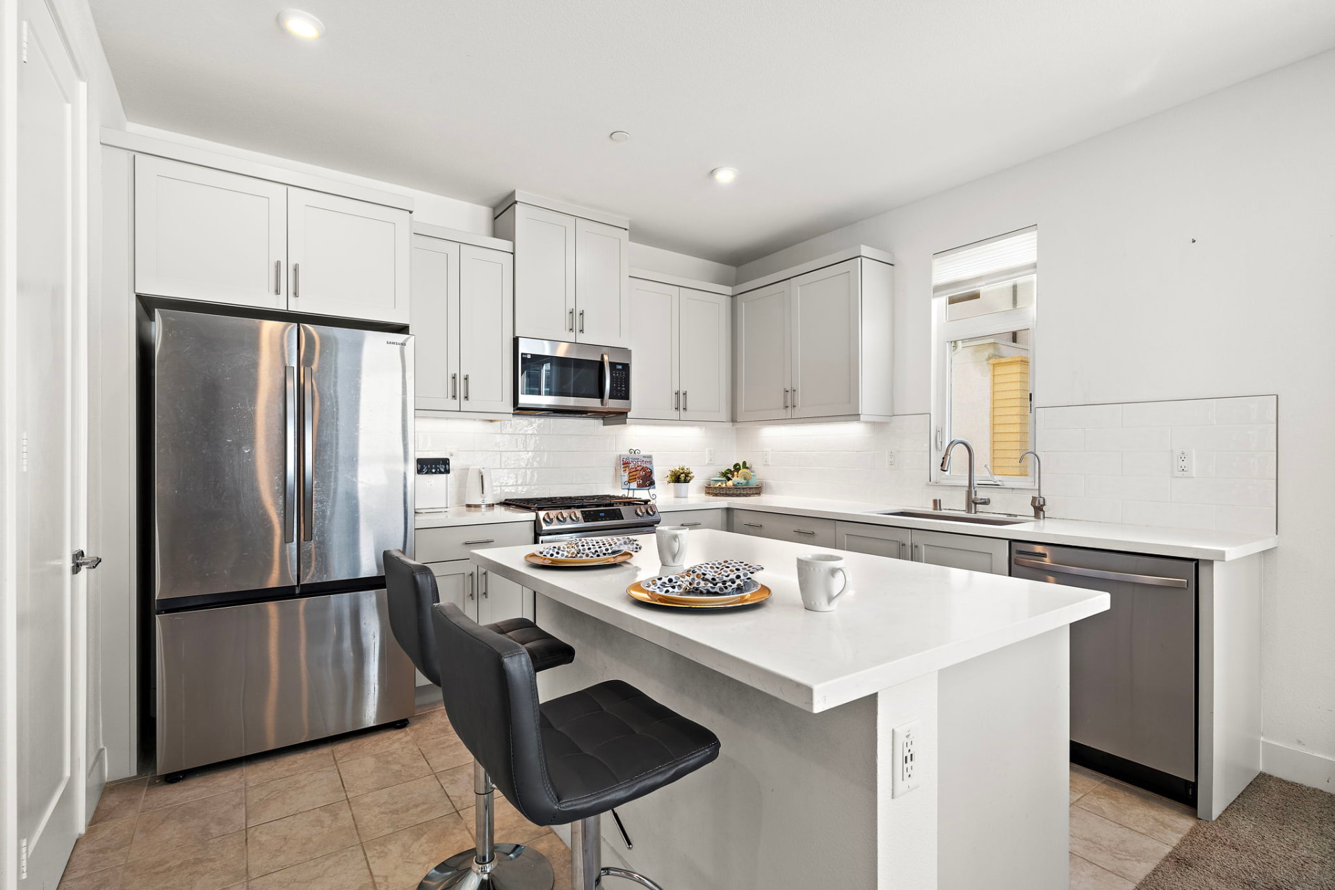 Modern kitchen with quartz countertops and center island at 230 Abacus