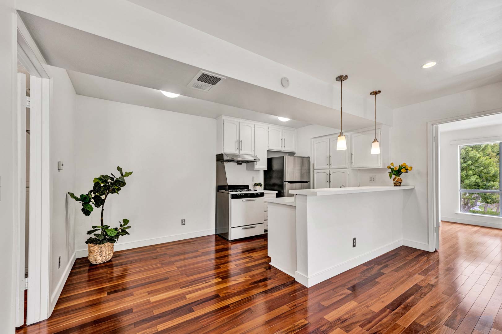 Bright open living and kitchen area with hardwood floors in Santa Ana condominium