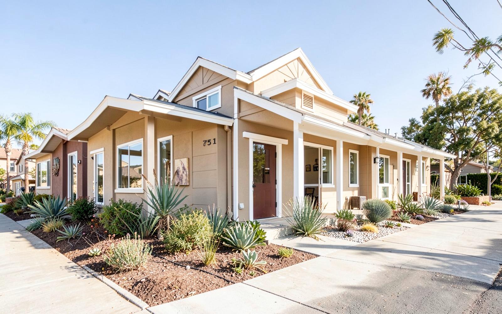 Row of modern Orange County townhomes with white trim and drought-tolerant landscaping