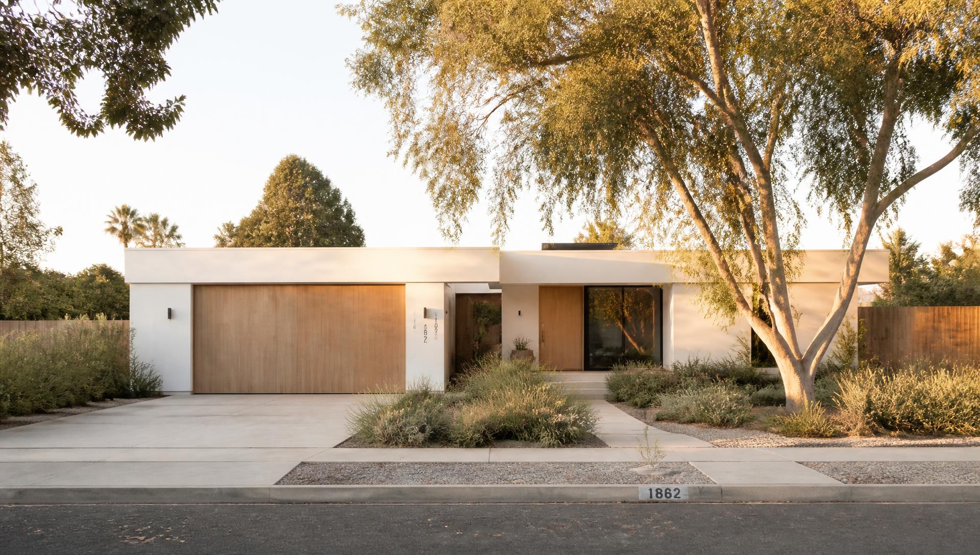 Warm minimalist Costa Mesa home exterior on a tree-lined residential street at golden hour